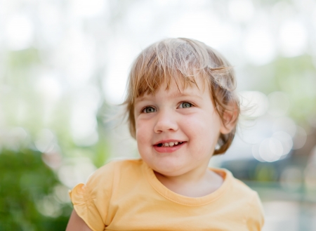  2 years  baby girl in yellow against skyの写真素材