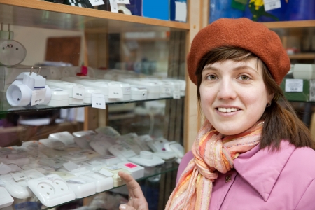 Young woman chooses  socket in  electrical storeの写真素材