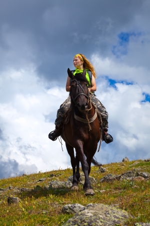 Happy girl riding a horse bareback の写真素材