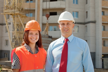 Portrait of two builders standing at building site の写真素材