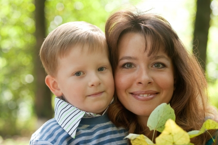 Happy mother with boy   against natureの写真素材