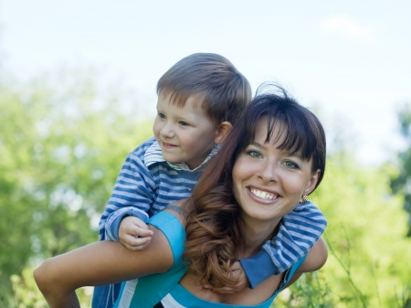 Happy mother with boy   against natureの写真素材