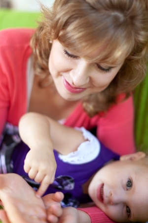 Happy mother with her baby in home interiorの写真素材