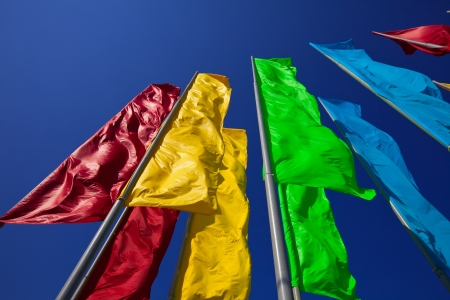 Colourful flags against the blue skyの写真素材