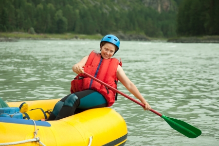 Girl with a paddle on the raftの写真素材