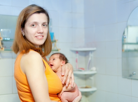 Mother with newborn baby in bahtroom. Focus on womanの写真素材