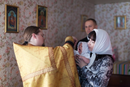 VLADIMIR, RUSSIA  - NOVEMBER 14: Priest at Sretenskaya church performing christening ceremony on November 14, 2012 in Vladimir, Russia.Child - daughter of photographer who gets religious name Elenaのeditorial素材