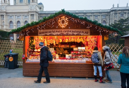 VIENNA, AUSTRIA - NOVEMBER 22: People walking at  Christmas Market at Maria-Theresien-Platz   in November 22, 2011 in Vienna, Austria.  Kiosk with cookies at Christmas market in Viennaのeditorial素材