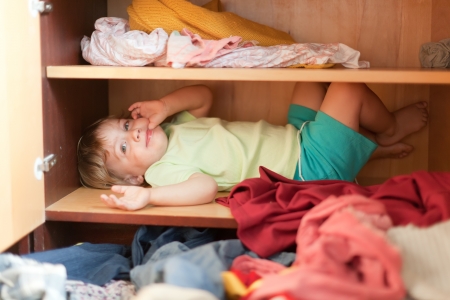  Baby girl is in the closet at homeの写真素材