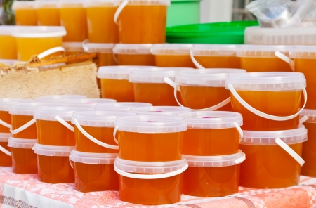assortment of honey on counter in market  の写真素材