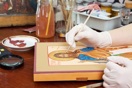 Iconographer makes new icon at painting workshopの写真素材
