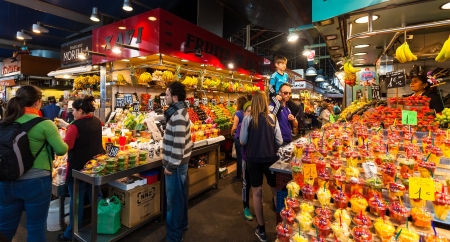 BARCELONA, SPAIN - MARCH 28: Vendors at La Boqueria market in March 28, 2013 in Barcelona, Spain.  The market is famous for its variety of fresh produceのeditorial素材