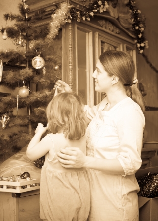  mother and child preparing for  Christmas at home. Imitation of an old imageの写真素材