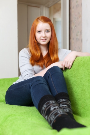 Portrait of ordinary red-haired girl in homeの写真素材