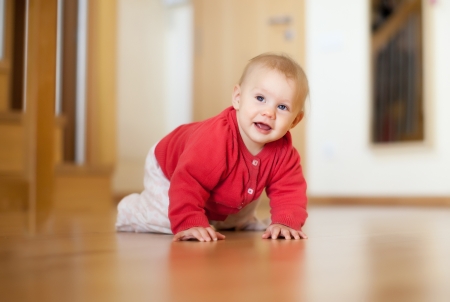 7 months baby girl smiling on floorの写真素材