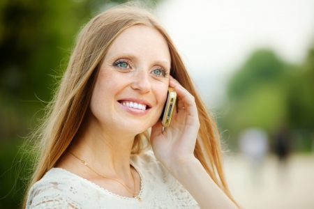 Positive woman calling by mobile with copyspaceの写真素材