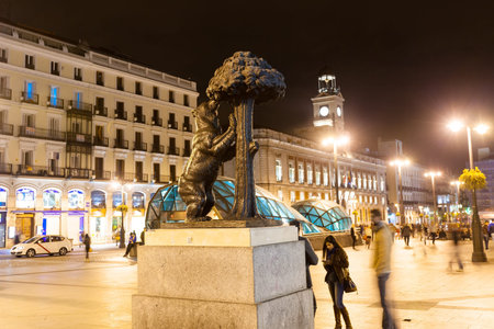 MADRID, SPAIN - APRIL 26: Bear and the Madrono Tree  in night  in April 26, 2013 in Madrid, Spain. It is  heraldic symbol of city, located at Puerta del Sol.のeditorial素材