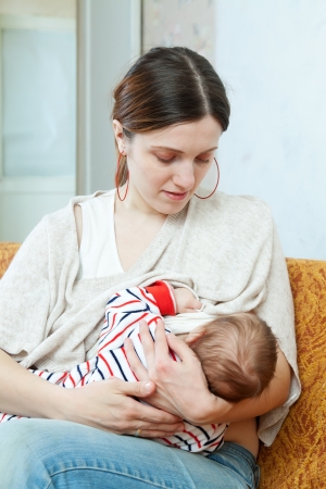 three-month baby sucks breast of the motherの写真素材