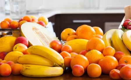 fresh fruits at table in domestic kitchen  の写真素材