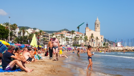 SITGES, CATALONIA - AUGUST 6: People at  beach in Sitges in August 6, 2013 in Sitges, Catalonia
Resort town known for its sandy beachのeditorial素材