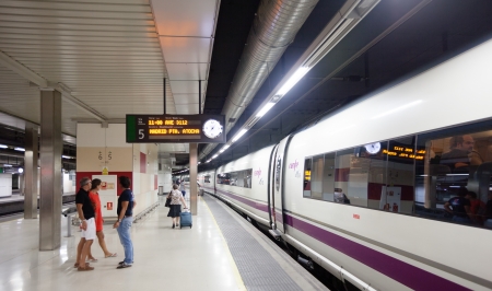 BARCELONA, SPAIN - AUGUST 22: Sants railway station in August 22, 2012 in Barcelona, Spain. AVE Train on the platformのeditorial素材