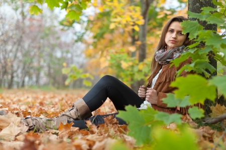 Girl in jacket at autumn park の写真素材