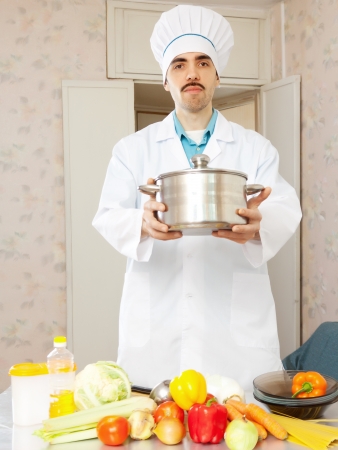 Portrait of male caucasian cook in uniform with panの写真素材