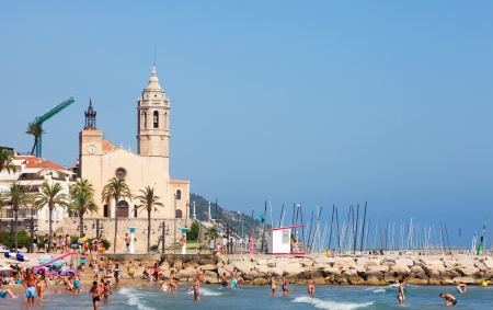 SITGES, SPAIN - AUGUST 6: Summer view of Mediterranean sand beach in August 6, 2013 in Sitges, Spain. 
Town is known for its sandy  coastのeditorial素材