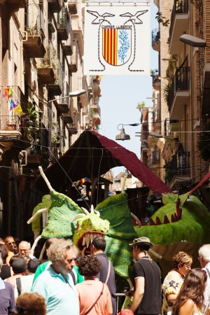 BARCELONA, SPAIN - AUGUST 15: Gracia Festa Major in August 15, 2013 in Barcelona, Spain.
Decorated streets of Gracia district. Dragon figurine of foam rubber on Llibertat streetのeditorial素材
