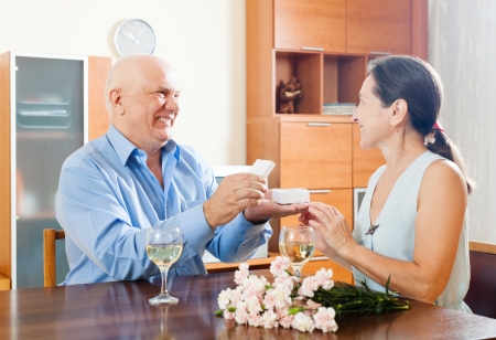 Happy mature couple having romantic date at homeの写真素材