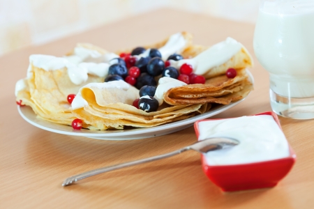 Breakfast. Pancakes on white plate with cranberries and blueberriesの写真素材