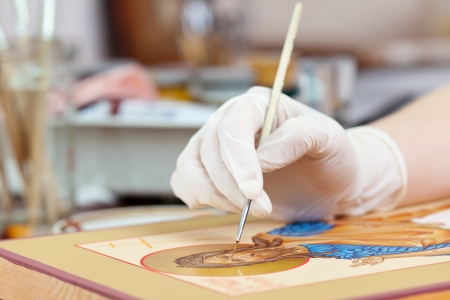 Artist paints of new icon with brush at workshopの写真素材
