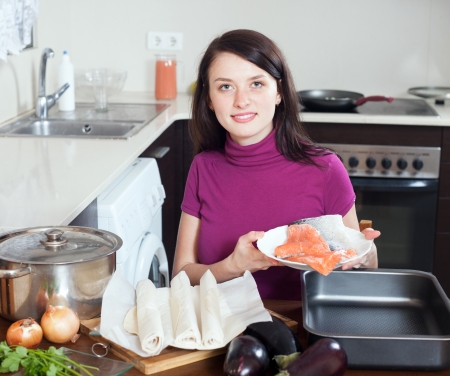  girl cooking fish pie with  salmon at home kithenの写真素材