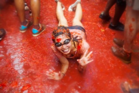 BUNOL, SPAIN - AUGUST 28: Unidentified girl in La Tomatina festival in August 28, 2013 in Bunol, Spain.
La Tomatina festival where people are fighting with tomatoes at streetのeditorial素材