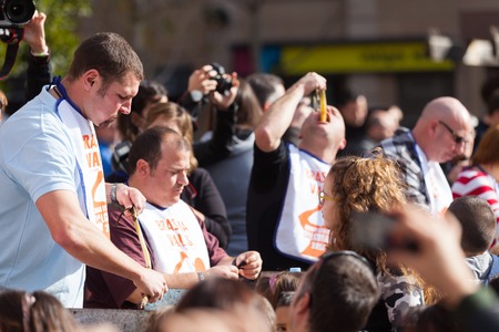 VALLS, CATALONIA - JANUARY 26, 2014  Competition for best eater of  calsot during Calcotada in Vallsのeditorial素材