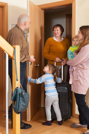 Family with two children coming to grandmother homeの写真素材