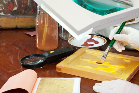icon-painter works on new gilded icon at icon painting workshopの写真素材