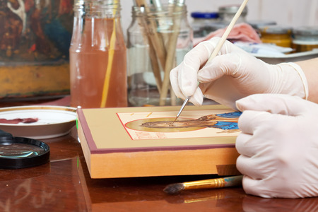 Icon painter makes new Christian icon with Christ at art icon-painting workshopの写真素材