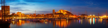 Panorama of port with yachts against cityspace and Castle of Santa Barbara in night  Alicante, Spainの写真素材