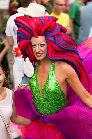 SITGES, SPAIN - JUNE 15, 2014: Person in costume with plumage at   Gay pride parade in Sitges. Cataloniaのeditorial素材