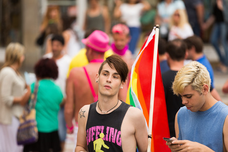 SITGES, CATALONIA - JUNE 15, 2014: Guys with  rainbow flag at Gay pride parade in Sitges. Cataloniaのeditorial素材