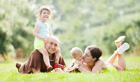  family of four enjoying time at park in summerの写真素材