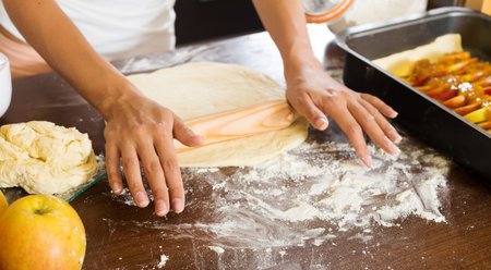 Closeup of woman making apple cake