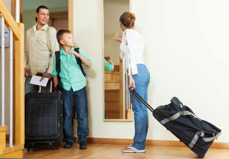 Ordinary family travelers with luggage  going on holidayの写真素材