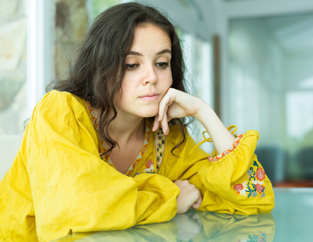 Portrait of upset young woman with eyes droppedの写真素材