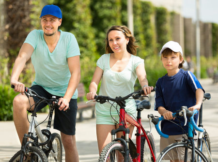 Summer vacation day of sports parents with son with bicycles