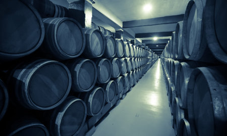 Vintage photo of old wine cellar with  wooden barrels