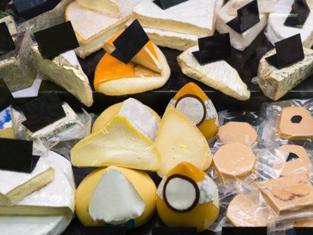 Cheese in packs and in bulk on counter at storeの写真素材