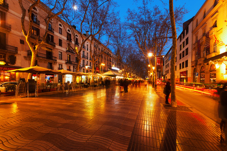 BARCELONA, SPAIN - MARCH 13, 2014: Evening view of Rambla in Barcelona. La Rambla is street in central Barcelona, between El Raval and Barri Gotic districtsのeditorial素材