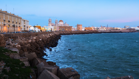 Ocean   embankment and Cathedral in twilight time. Cadiz, Spainの写真素材